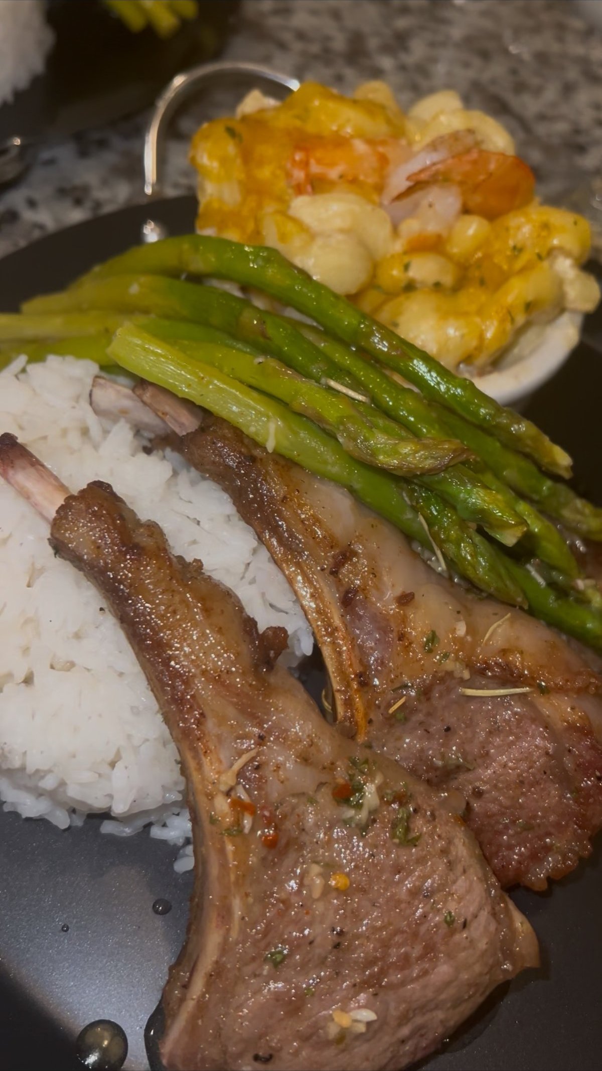 Lamb chops over rice with asparagus and a side of shrimp mac and cheese