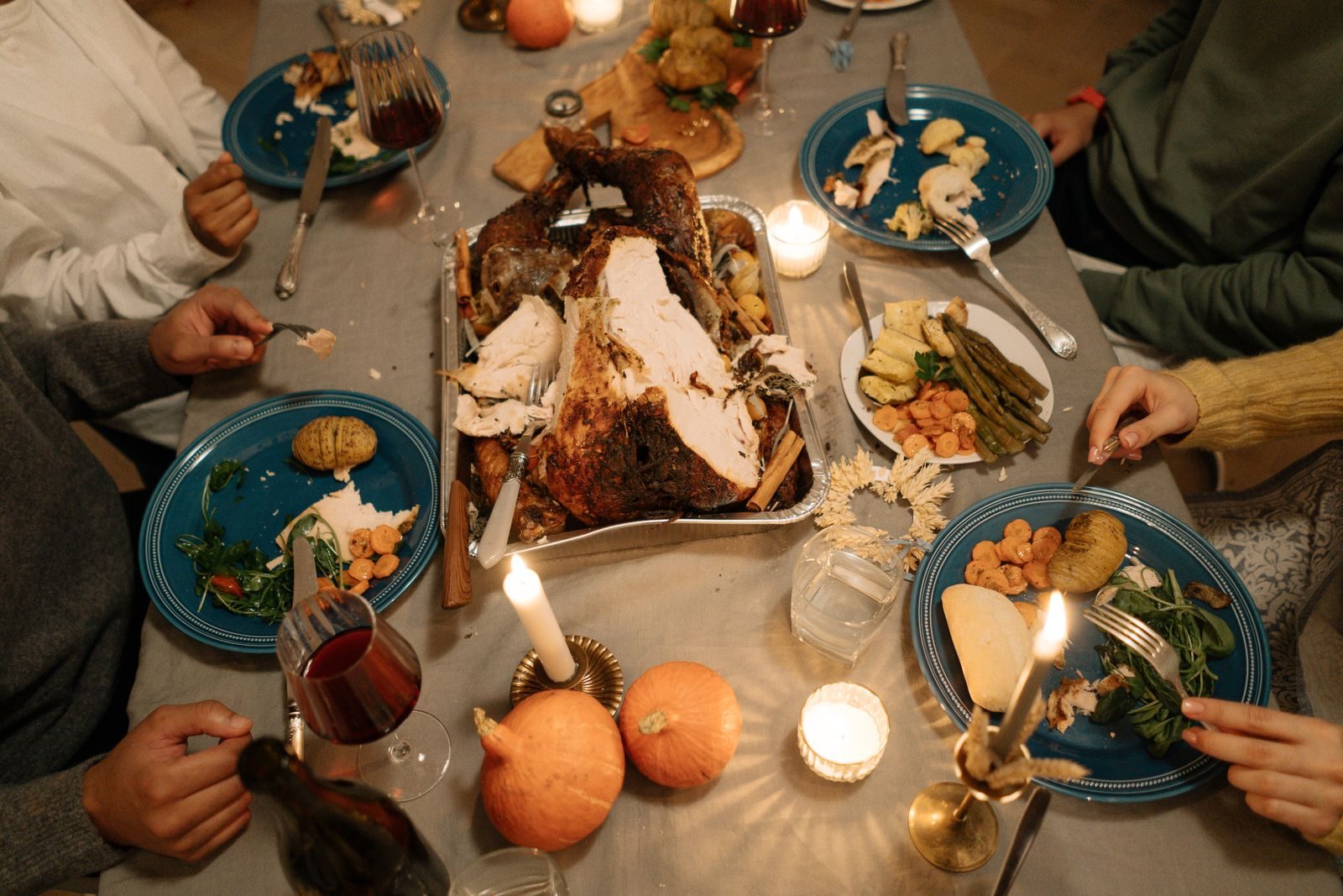 A candlelit table of people sharing a home-cooked meal